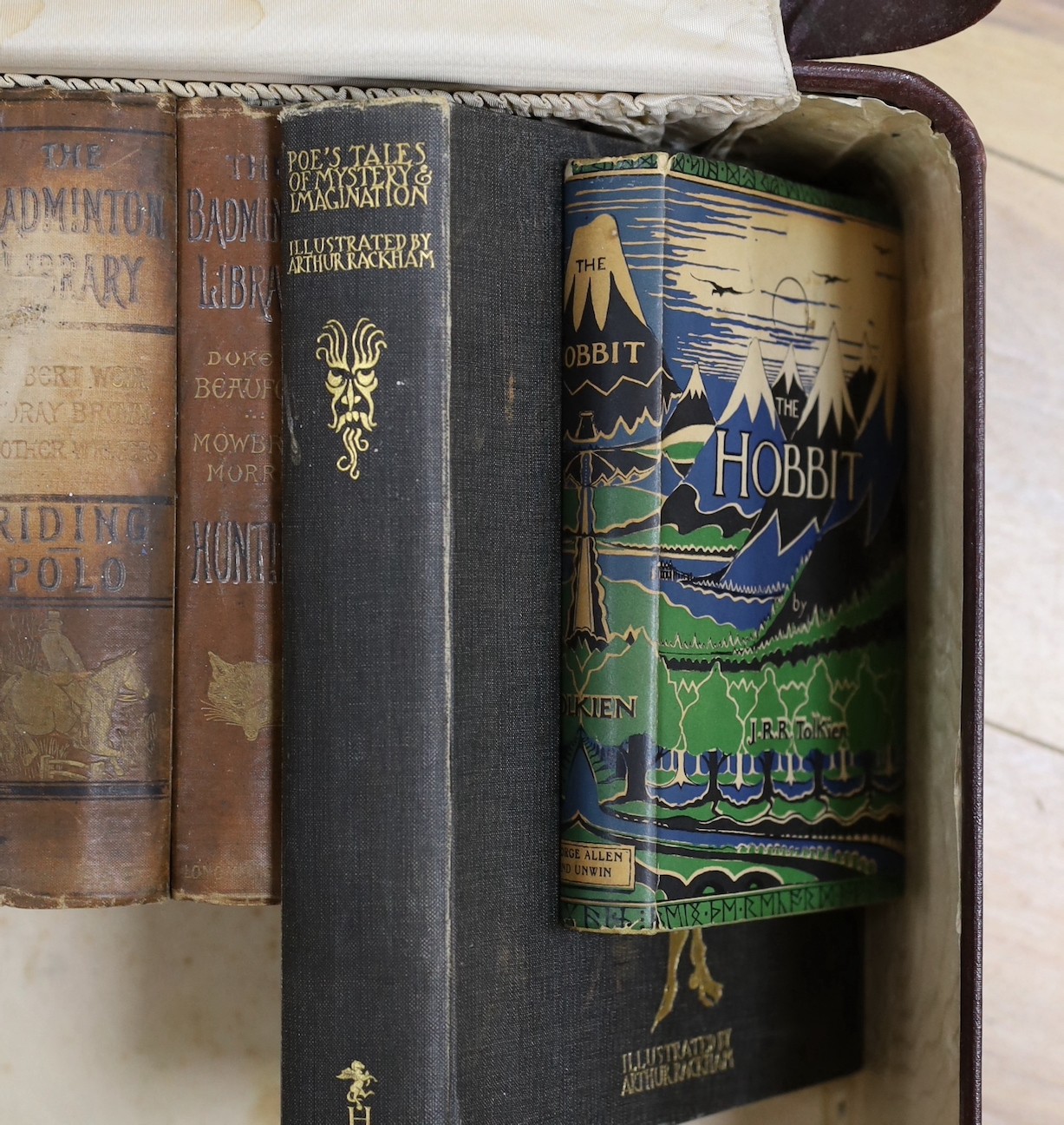 A quantity of leather bound books and a J R R Tolkein volume of The Hobbit with original dust jacket